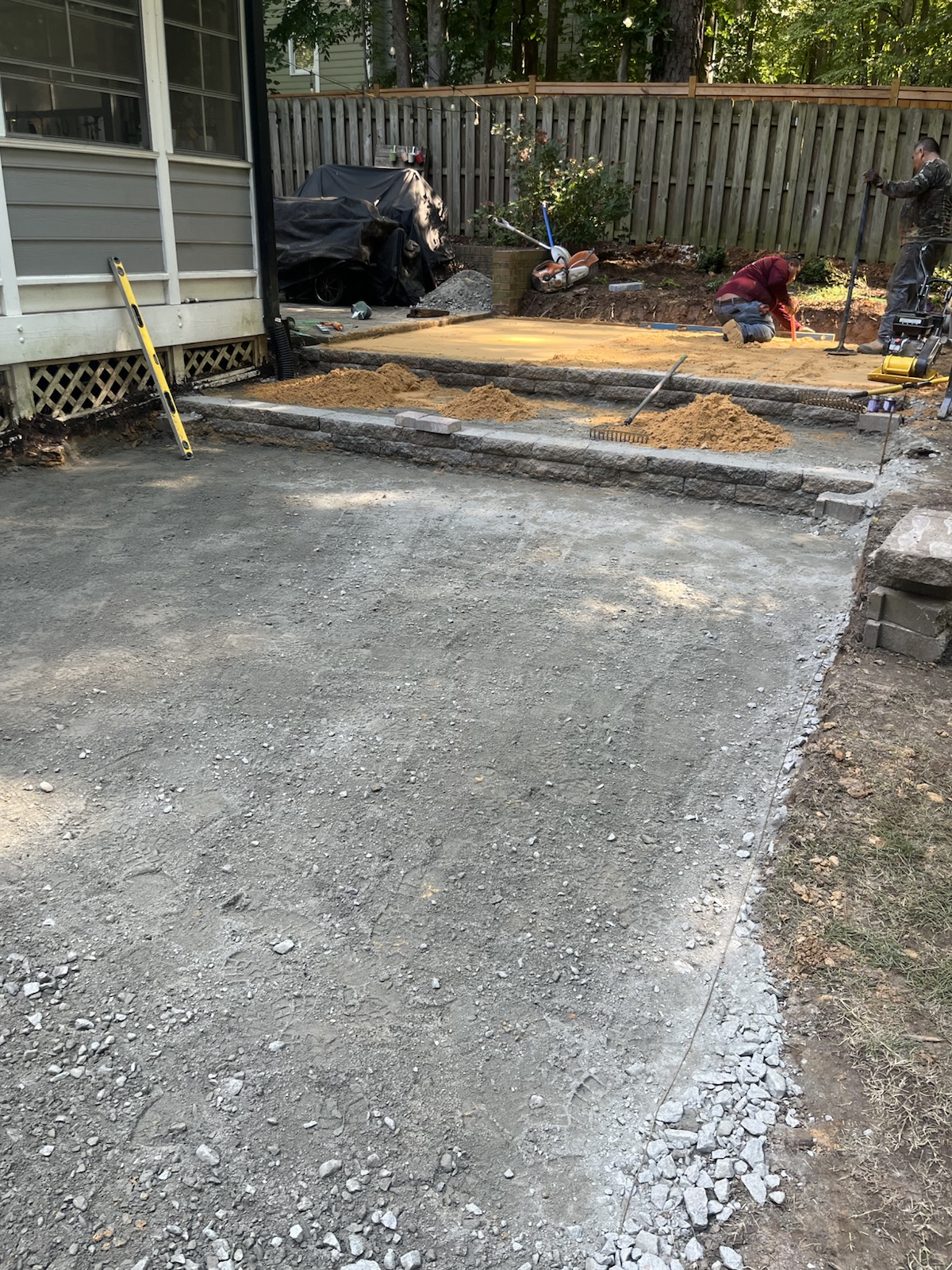 Base preparation underway during a residential paver patio project